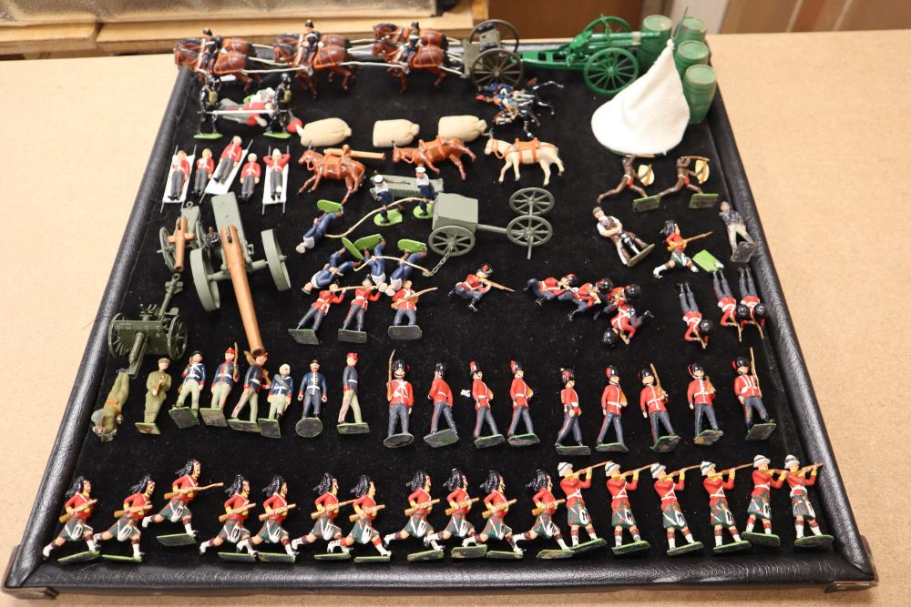 A collection of painted Britains and Holocast lead soldiers, artillery pieces, including some rare dated including Scots Guards chargin
